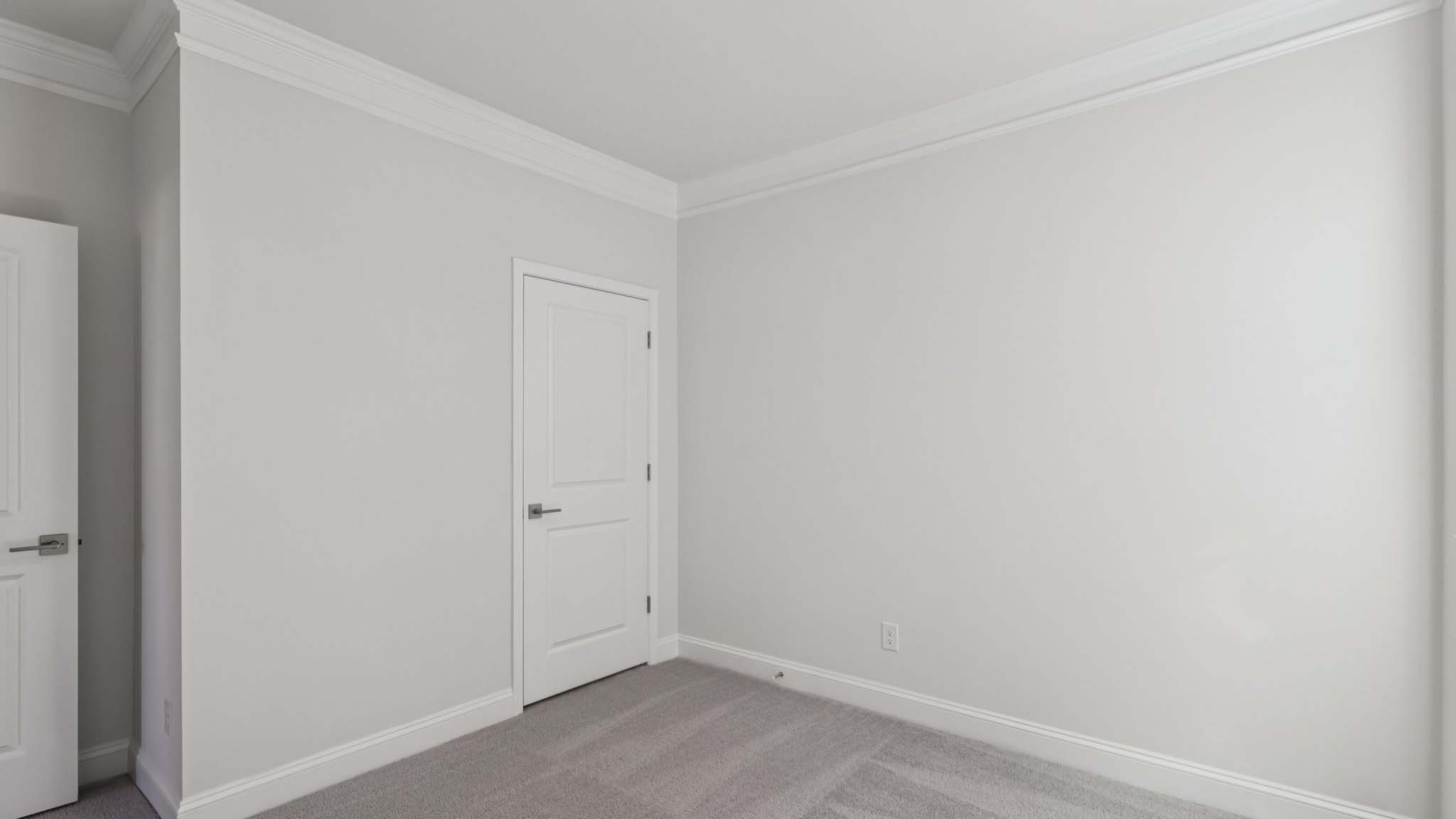 Carpeted bedroom with large window