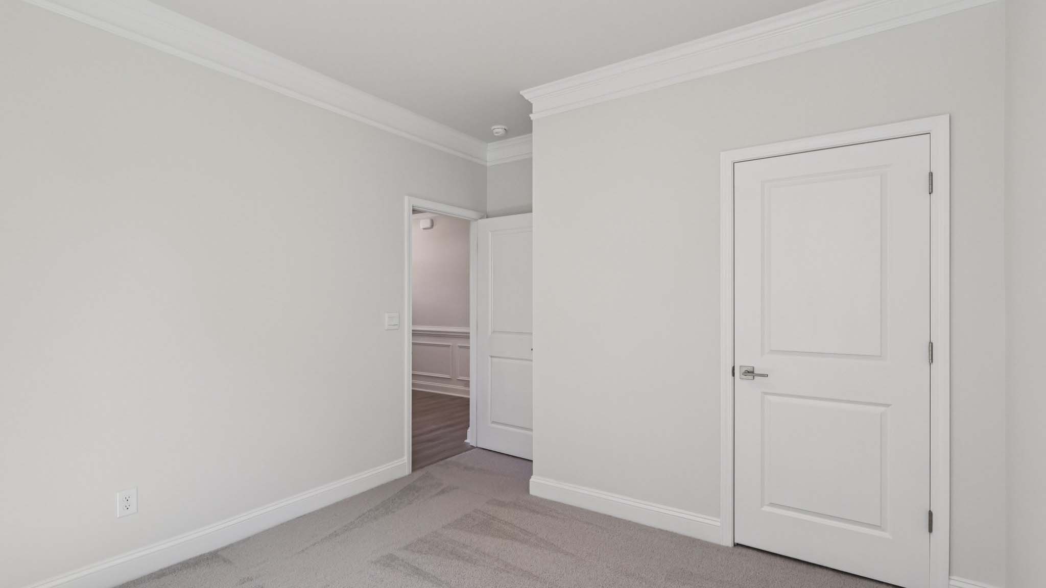 Carpeted bedroom with large window