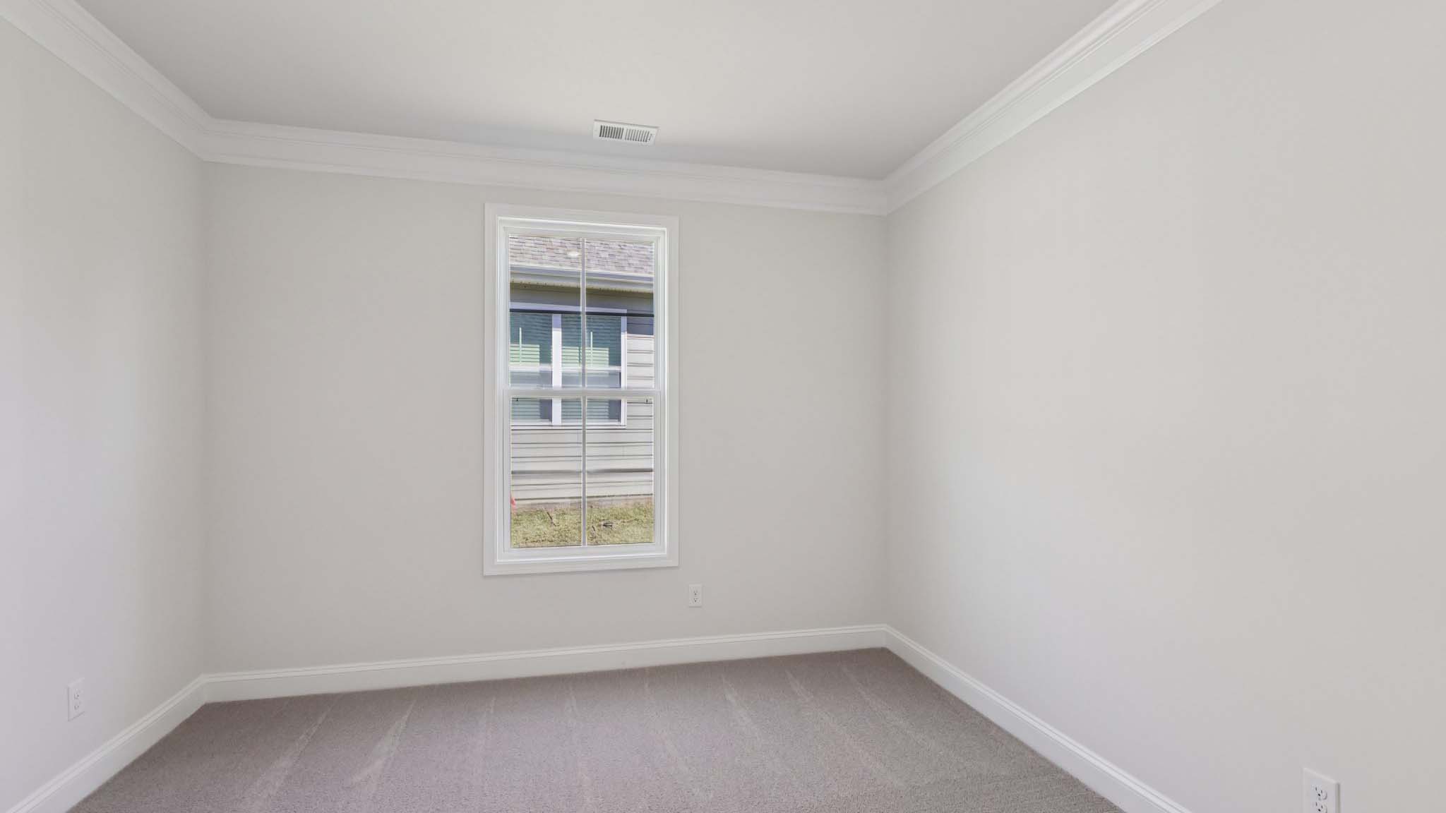 Carpeted bedroom with large window