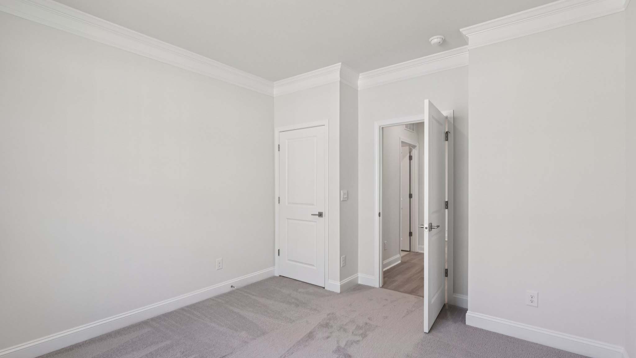 Carpeted bedroom with large window