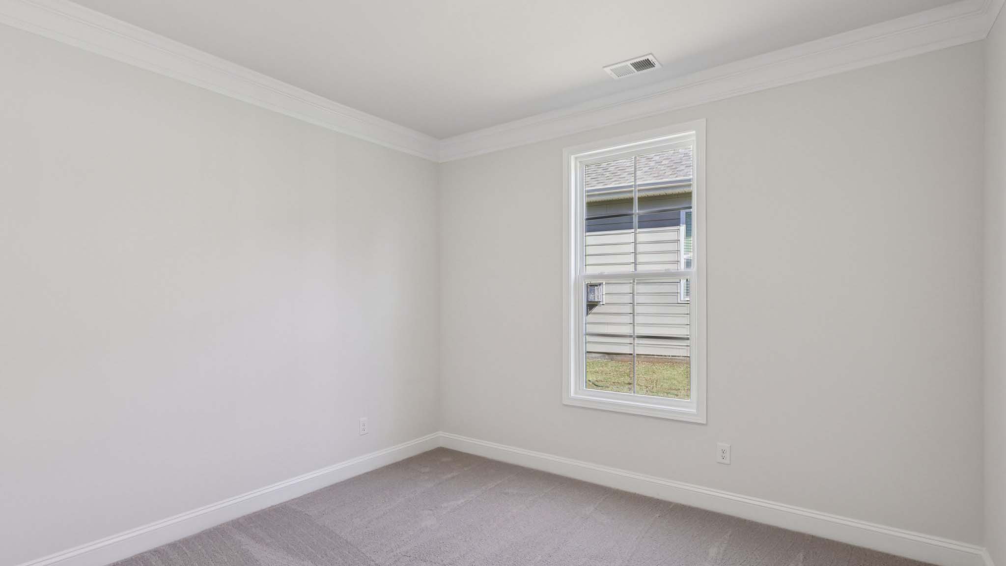 Carpeted bedroom with large window