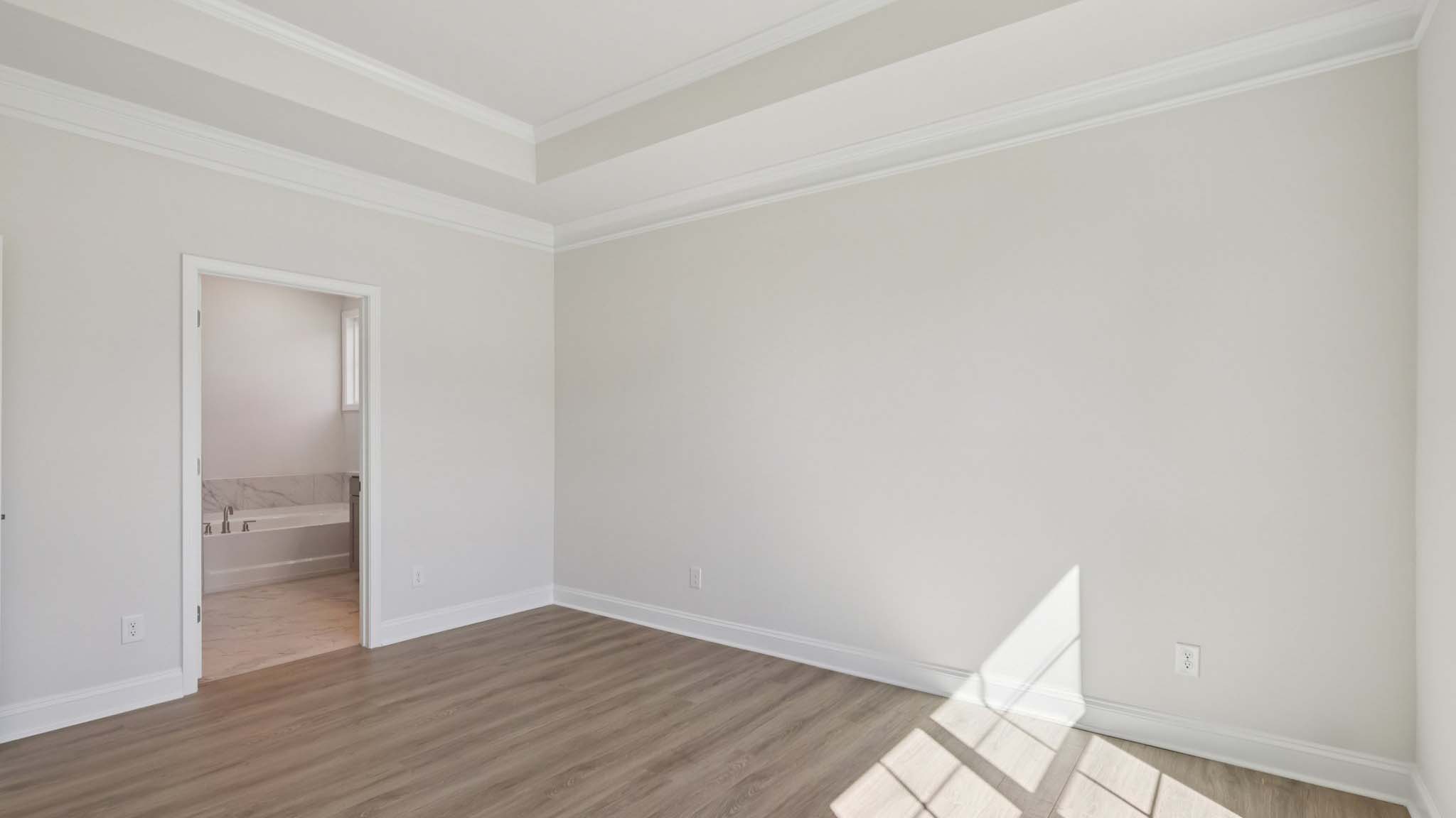 primary bedroom with vinyl flooring and large window
