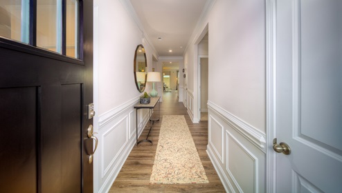 Welcoming foyer with wood floors, and view of interior
