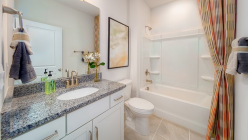 Bathroom with white cabinets, and bathtub