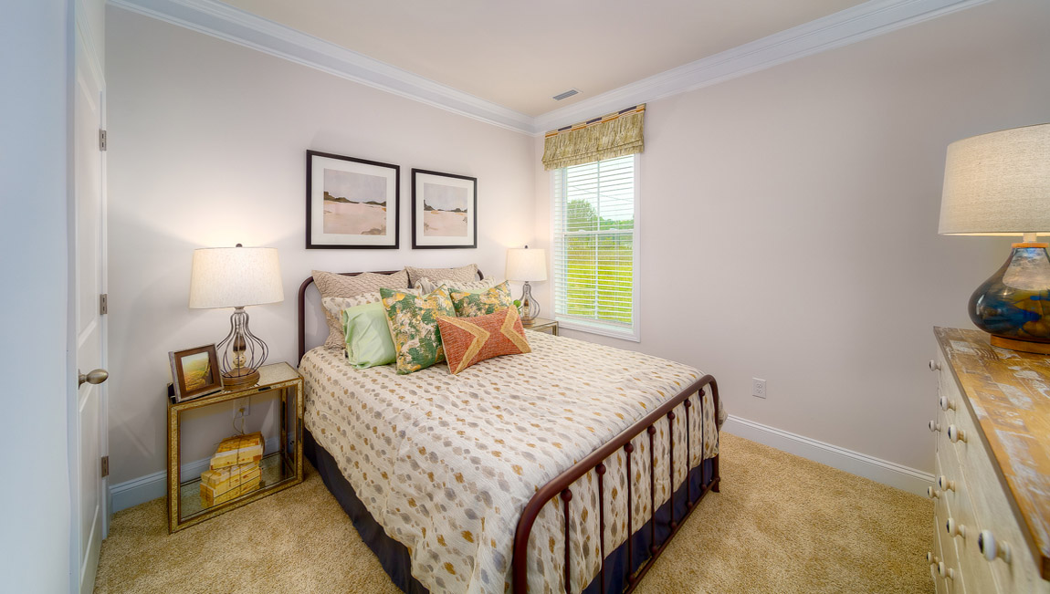 Carpeted bedroom with large window