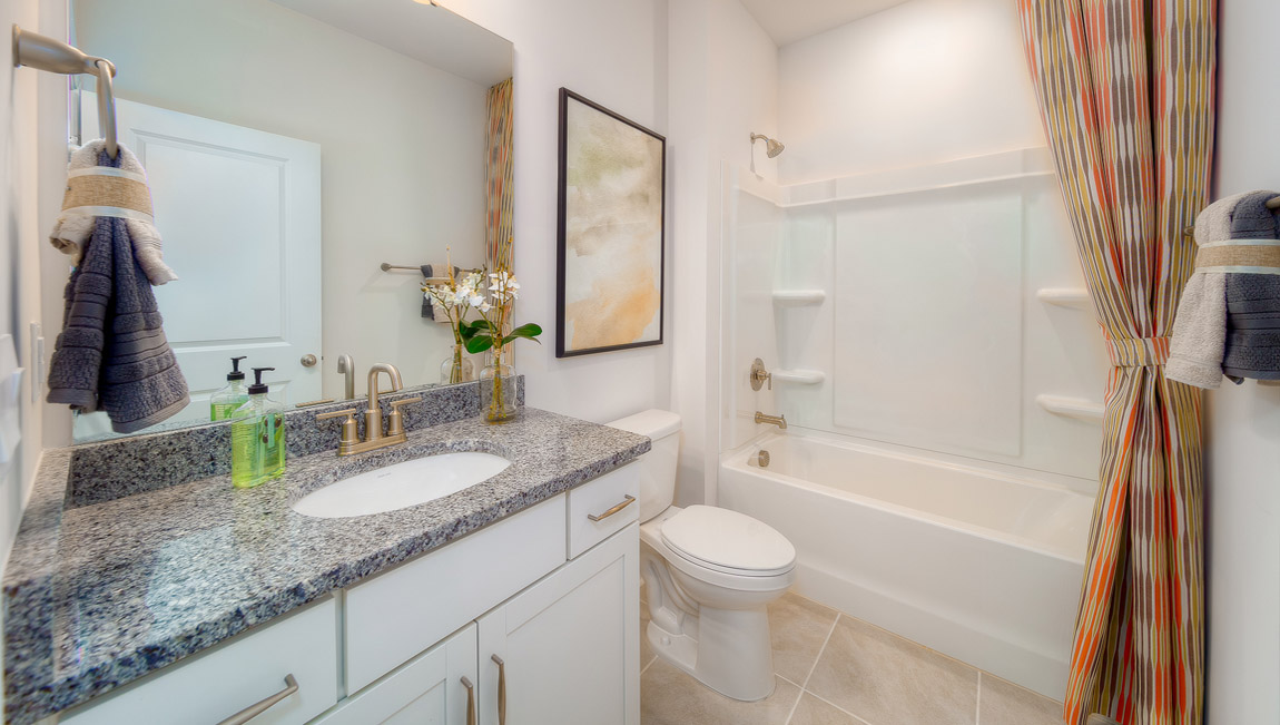 Bathroom with white cabinets, and bathtub