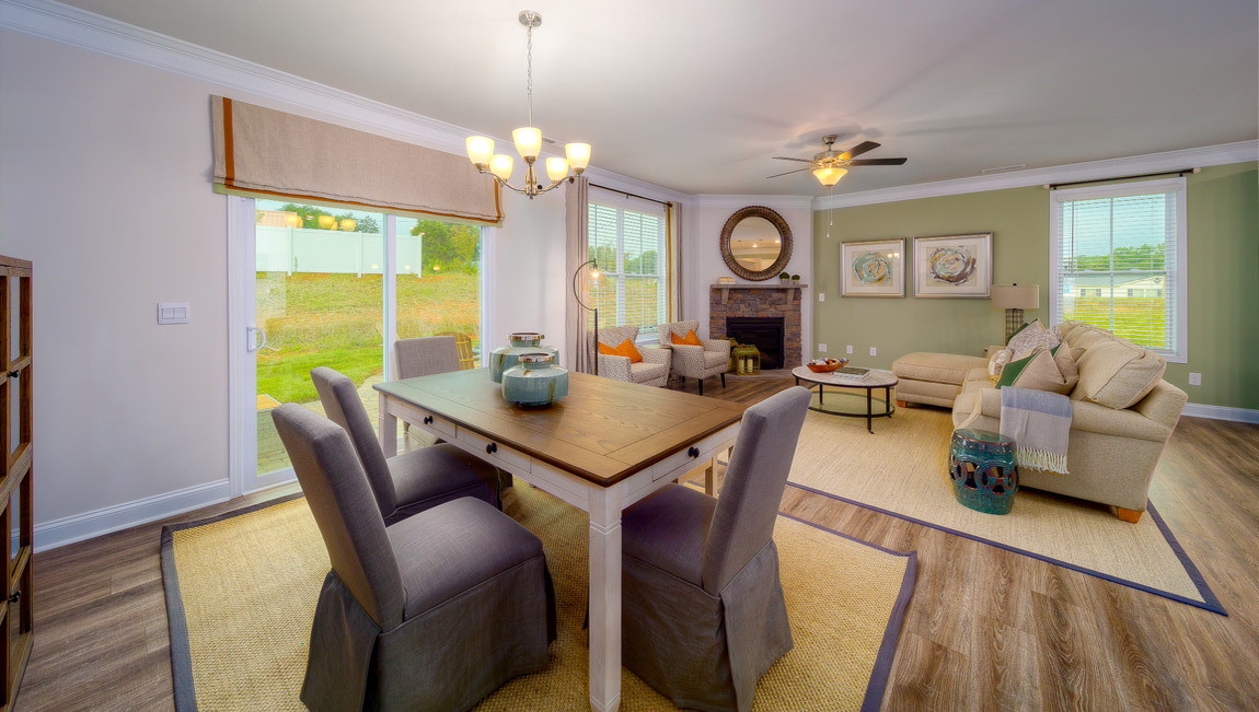 Dining area with wood floors, and sliding glass doors, view of living room
