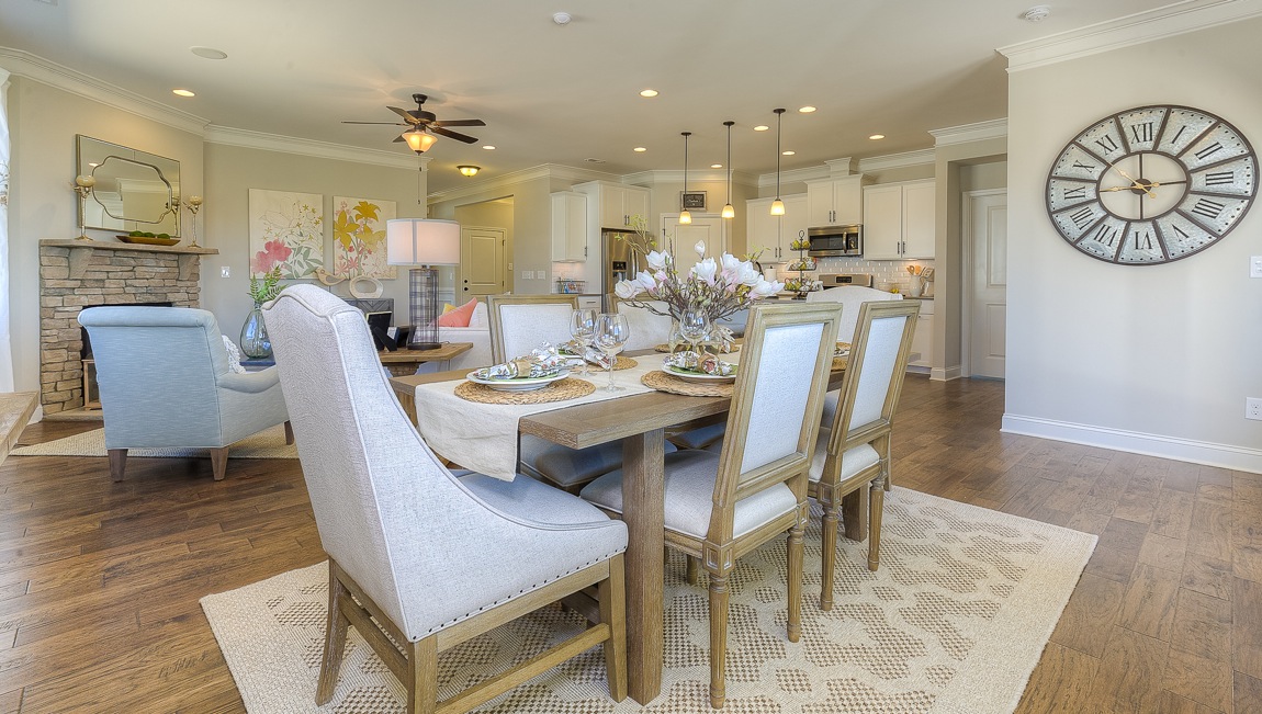 Dining room with wood floors, view of kitchen and family room