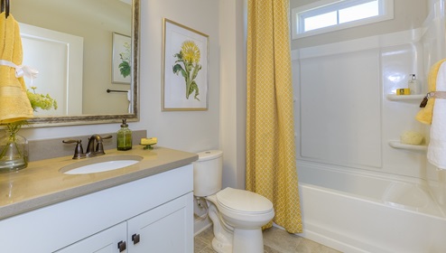 Bathroom with white cabinets and bathtub