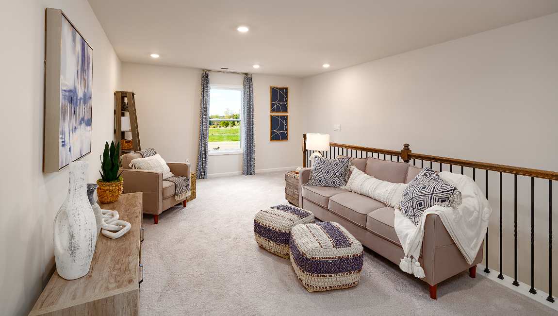 Upstairs carpeted loft with window by staircase
