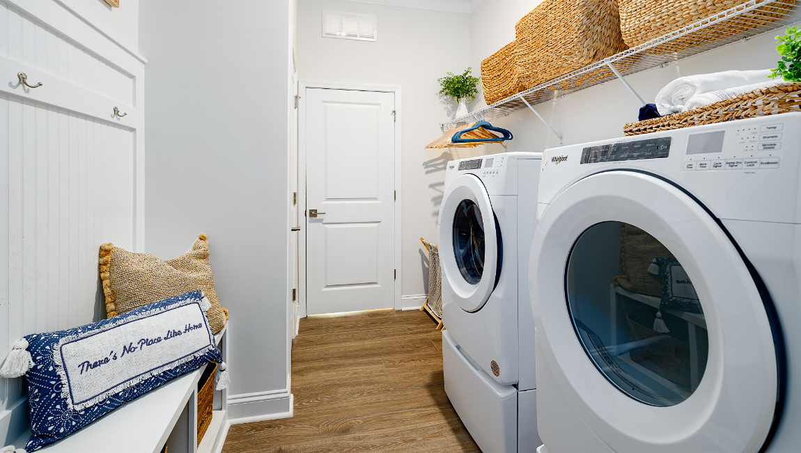 Laundry room with built in racks above machines