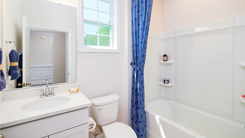 Bathroom with bathtub, whit cabinets and counters