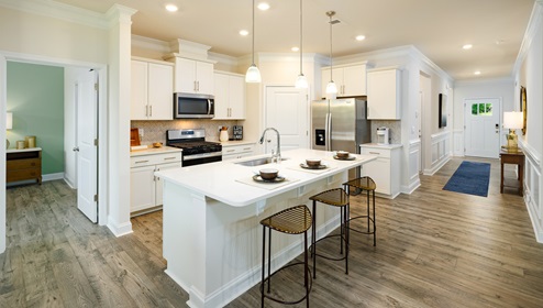 Kitchen and island, white counters and cabinets, wood floors