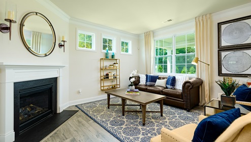 Living room space with large window and fireplace