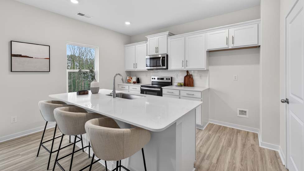 Kitchen and island with stainless steel appliances