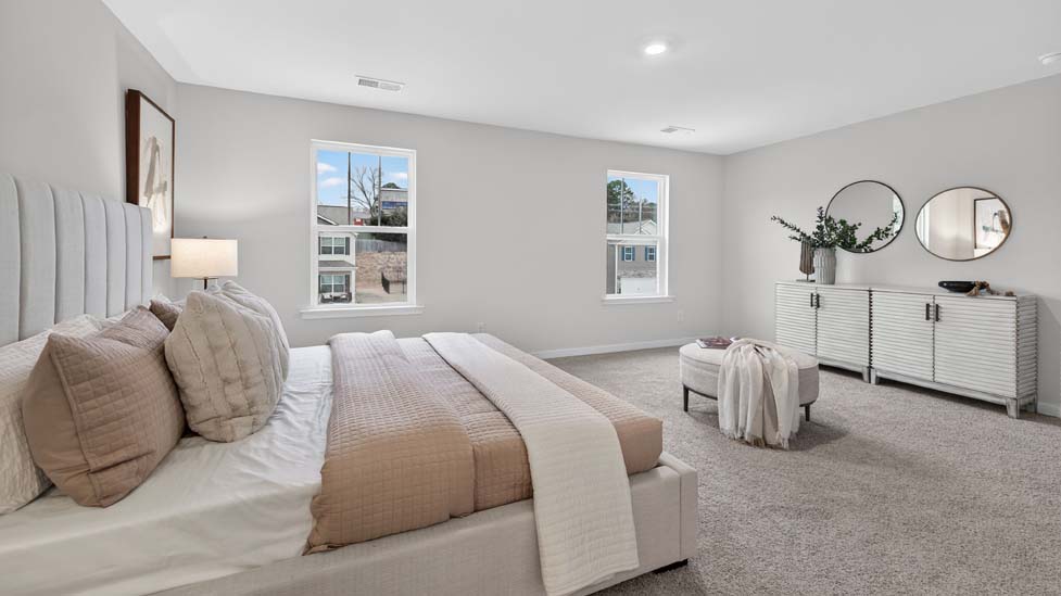 Carpeted bedroom with large windows