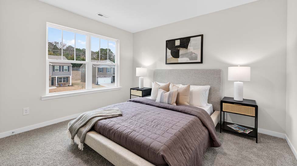 Carpeted bedroom with large window