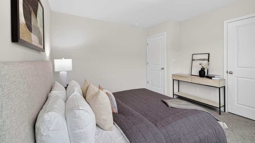Carpeted bedroom with large window