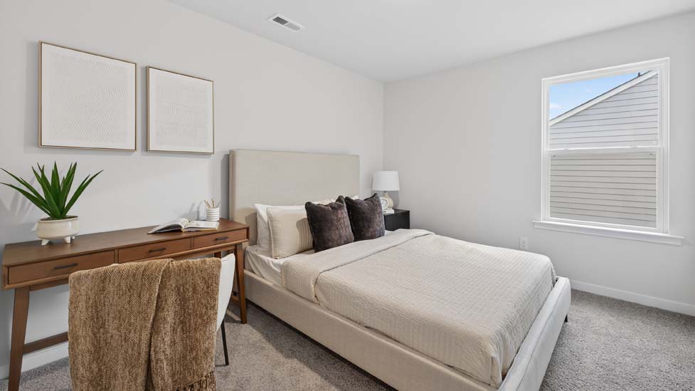 Carpeted bedroom with large window