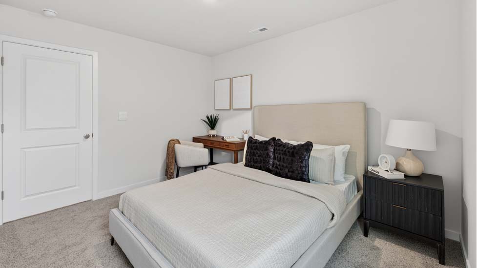 Carpeted bedroom with large window