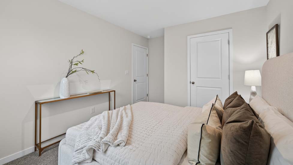 Carpeted bedroom with large window