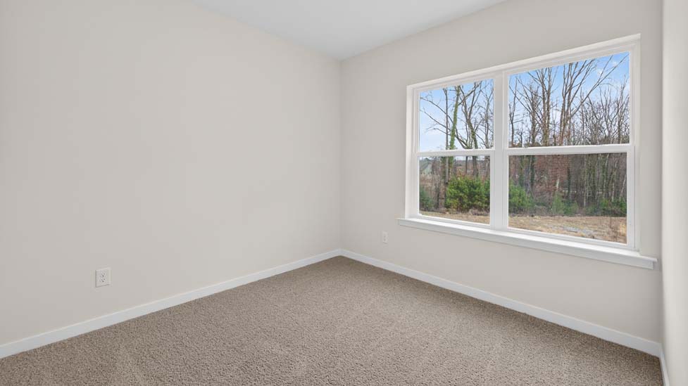 Carpeted bedroom with large window