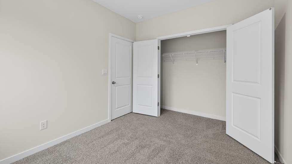 Carpeted bedroom with large window