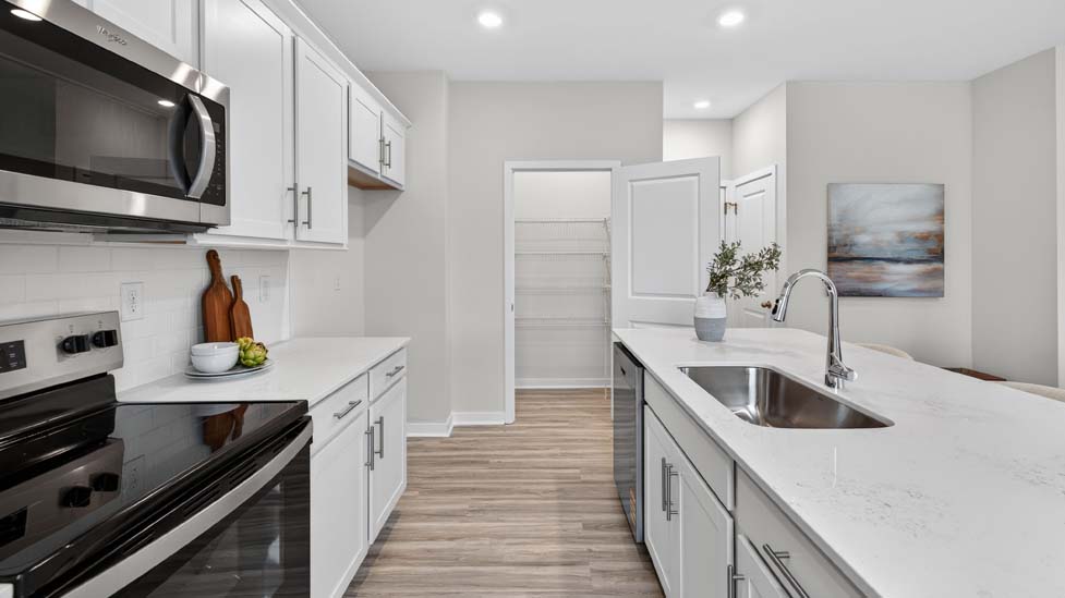 Kitchen and island with stainless steel appliances