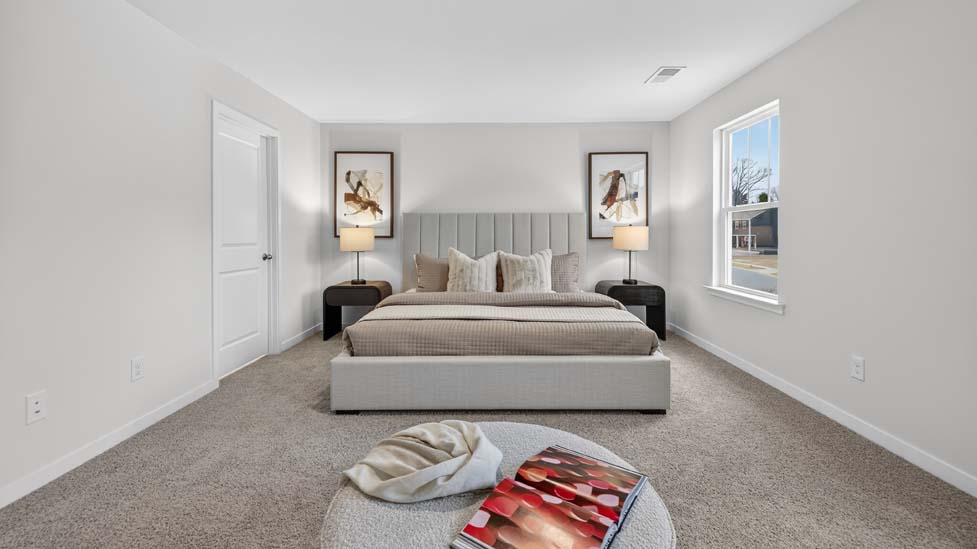 Carpeted bedroom with large windows