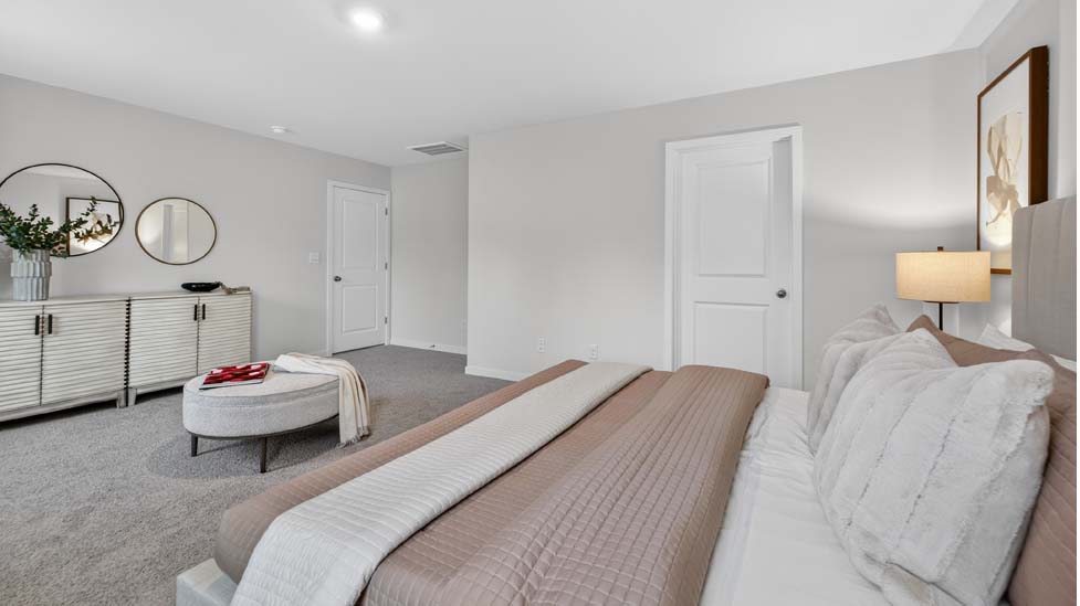 Carpeted bedroom with large windows