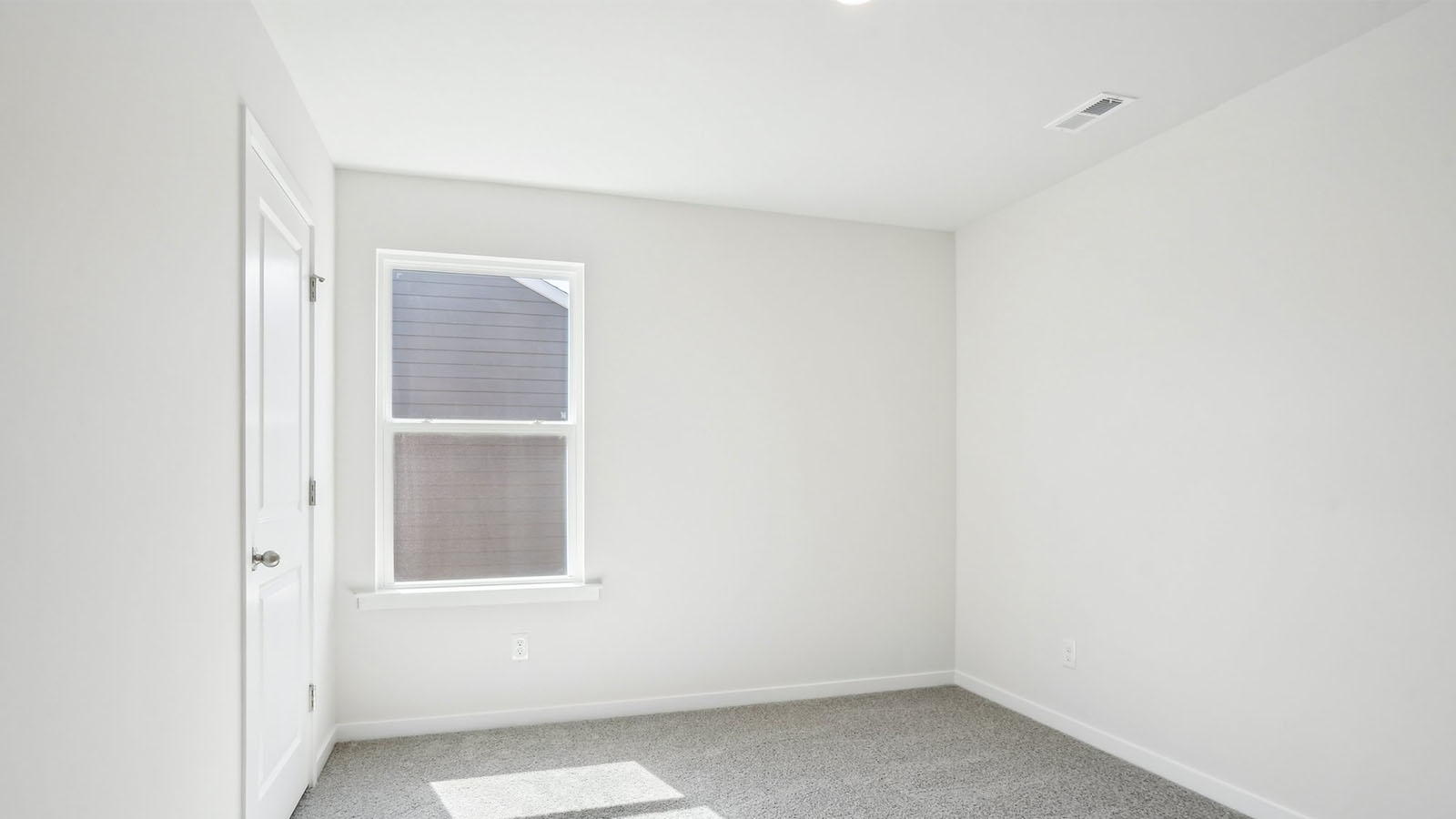 Carpeted bedroom with  window