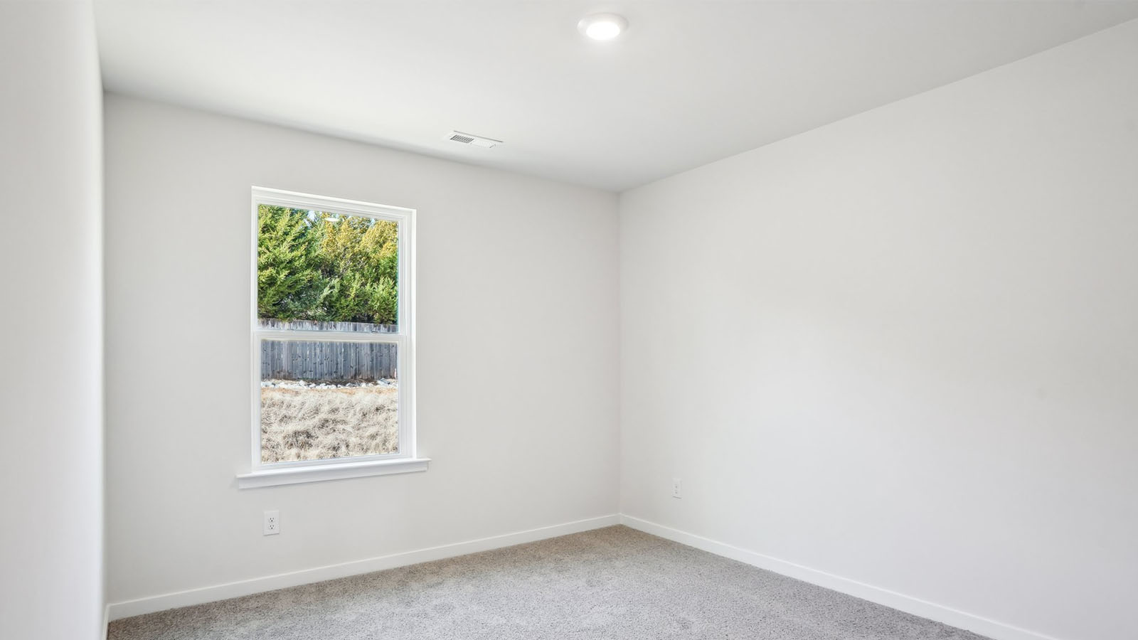 Carpeted bedroom with  window