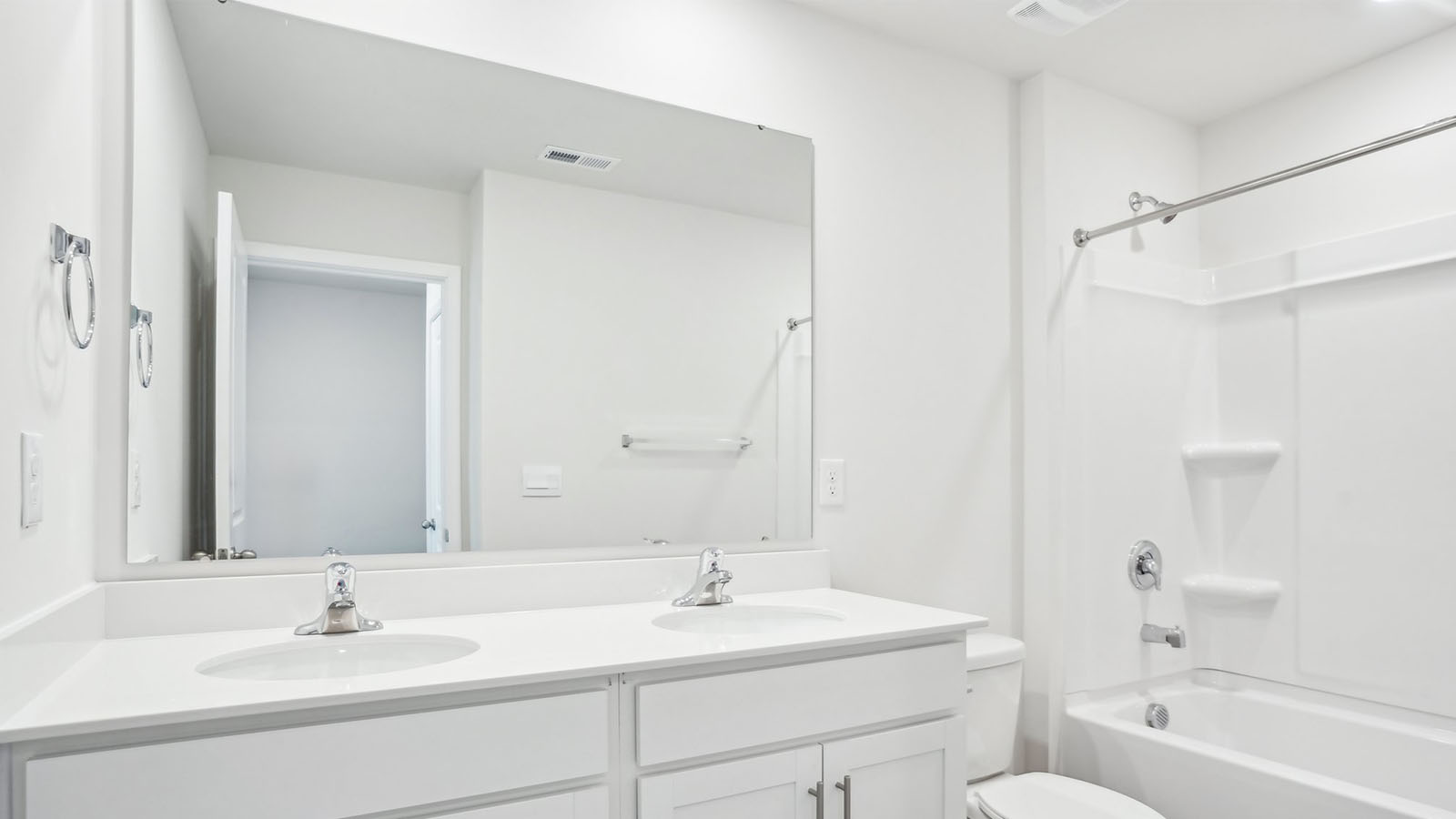 Bathroom with double sink vanity and bathtub shower combination