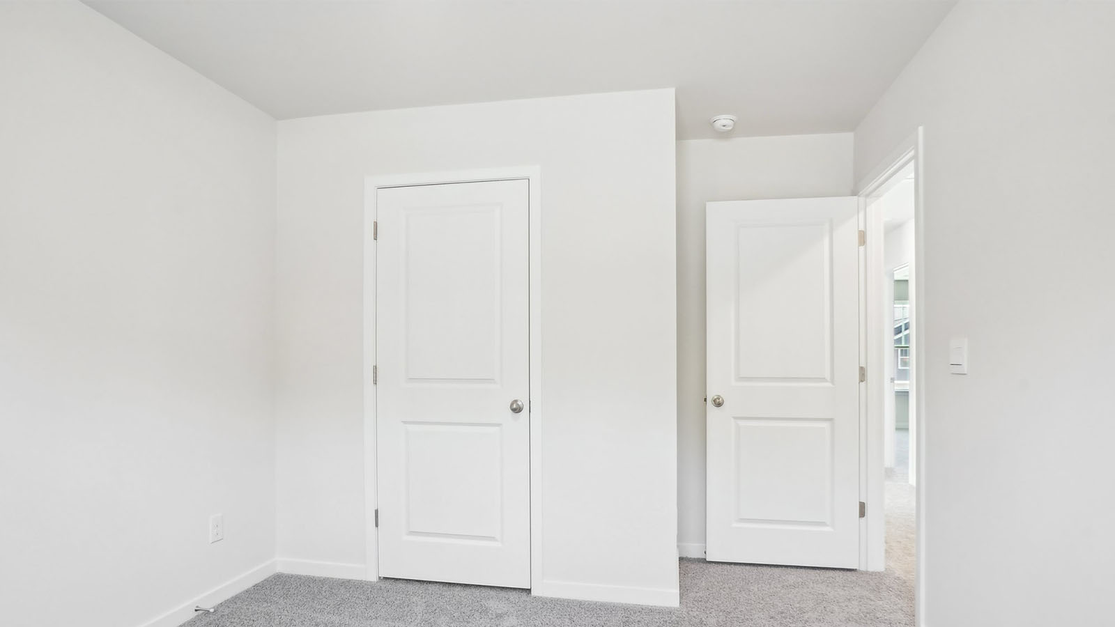 Carpeted bedroom with  window