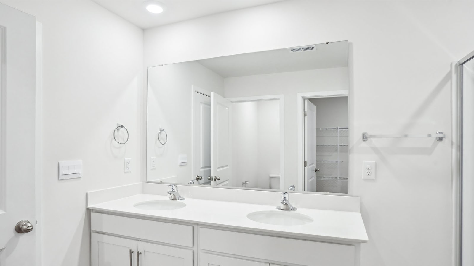 Bathroom with double sink vanity and bathtub shower combination