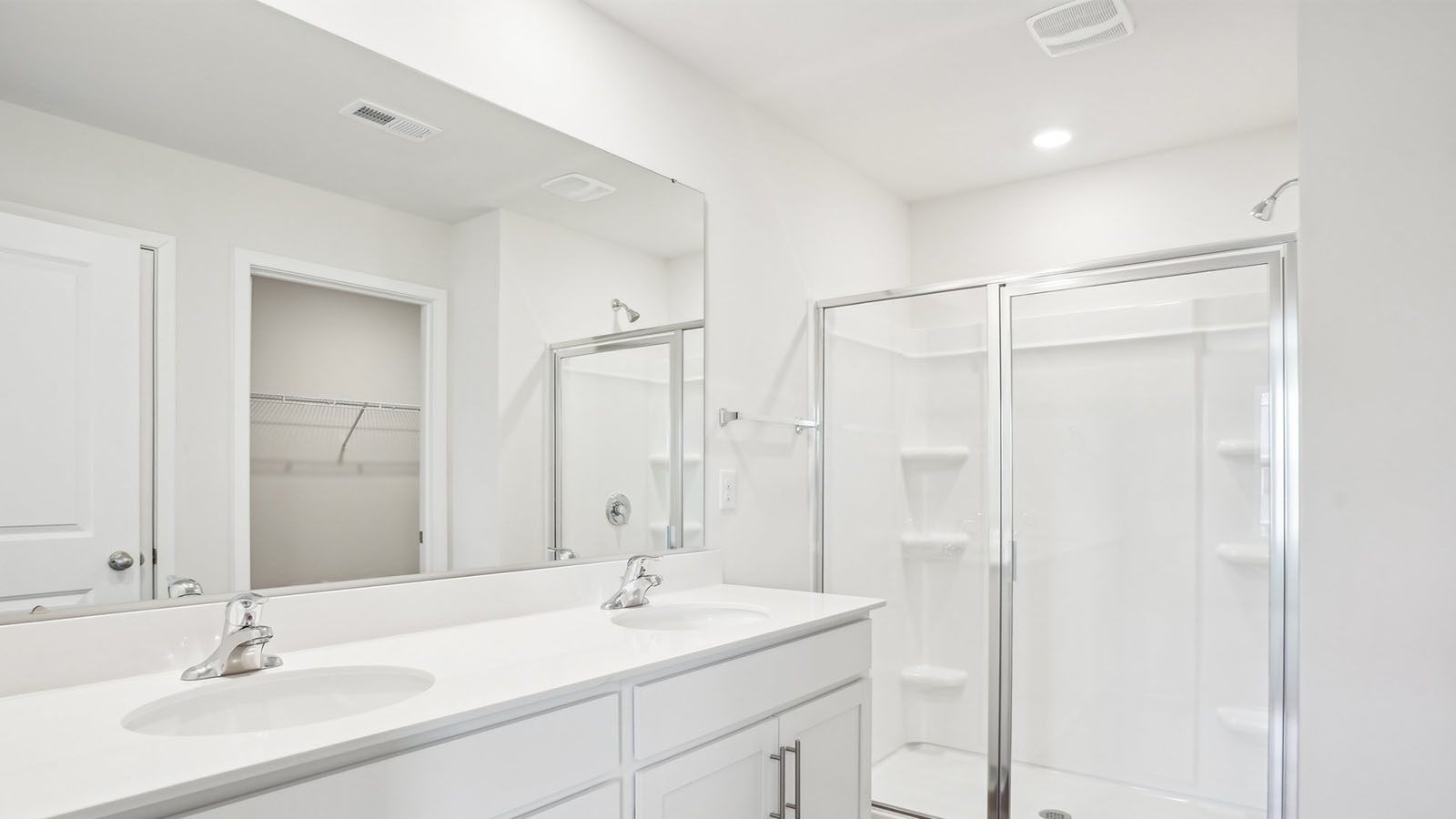 Bathroom with double sink vanity and bathtub shower combination