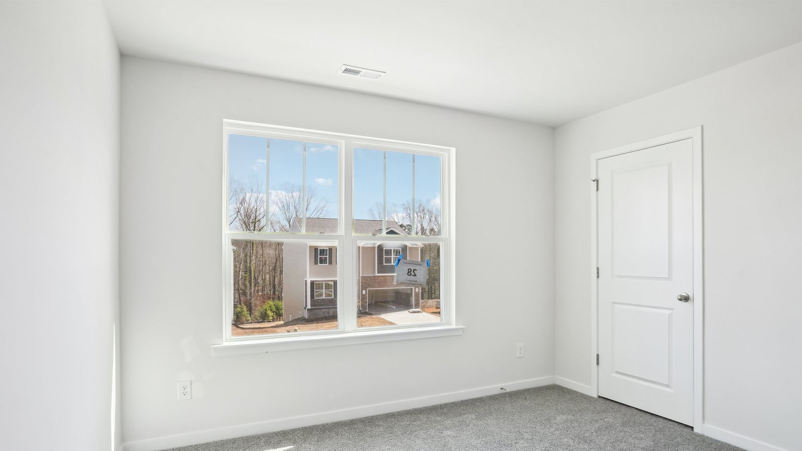 Carpeted bedroom with  window