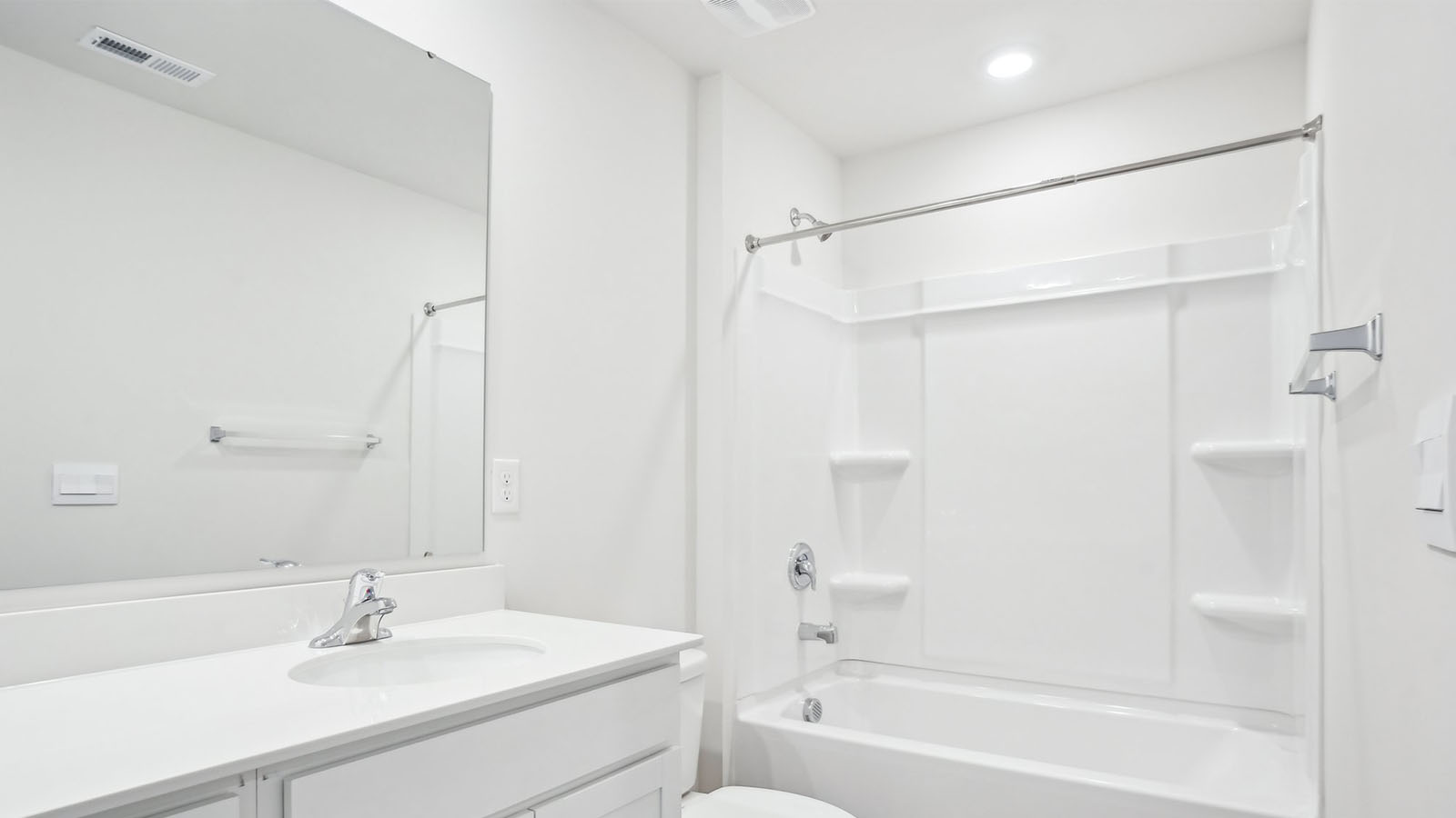 Bathroom with double sink vanity and bathtub shower combination