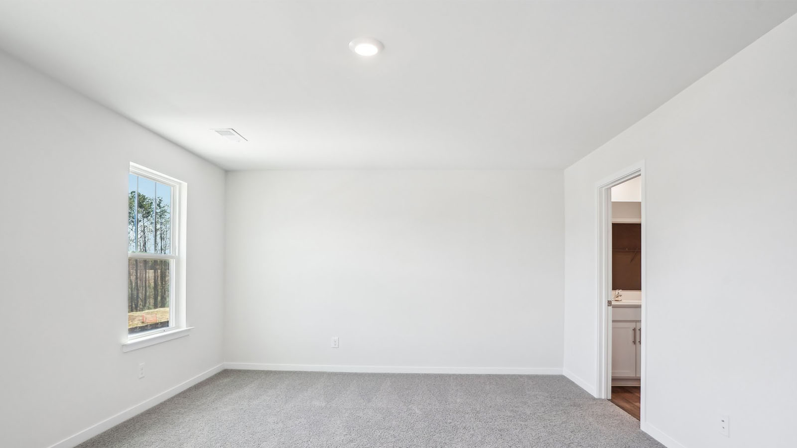 Carpeted bedroom with  window