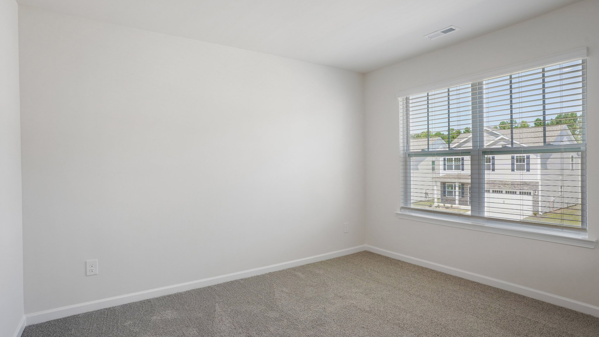 Carpeted bedroom with  window