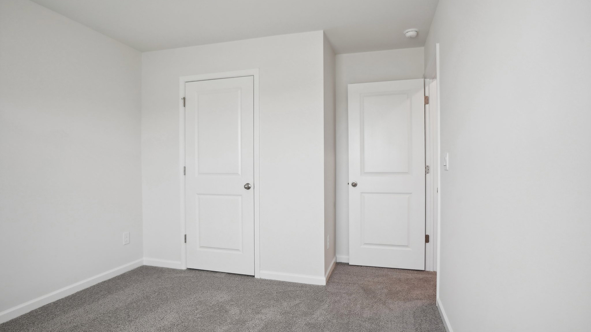Carpeted bedroom with  window