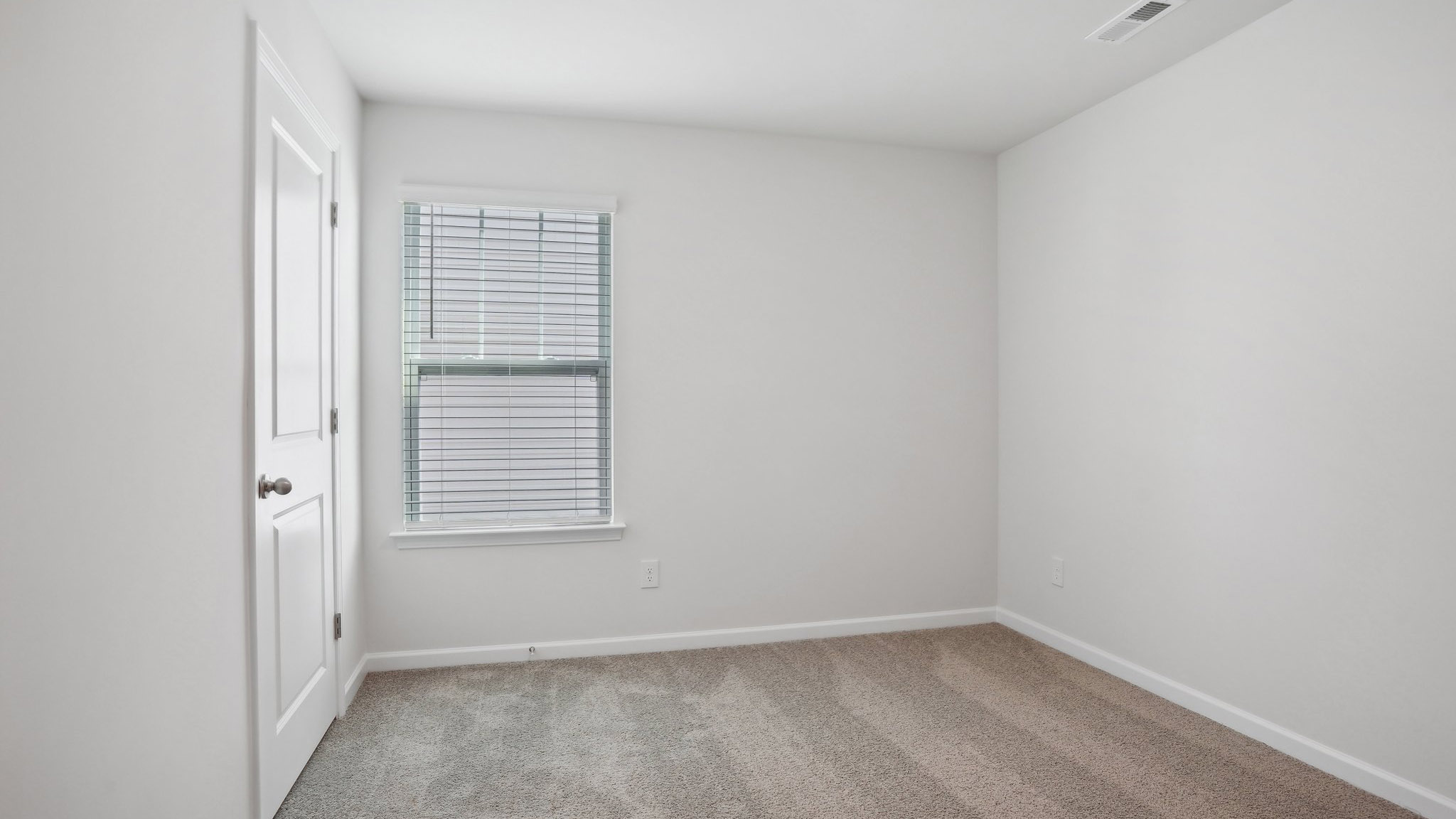 Carpeted bedroom with  window