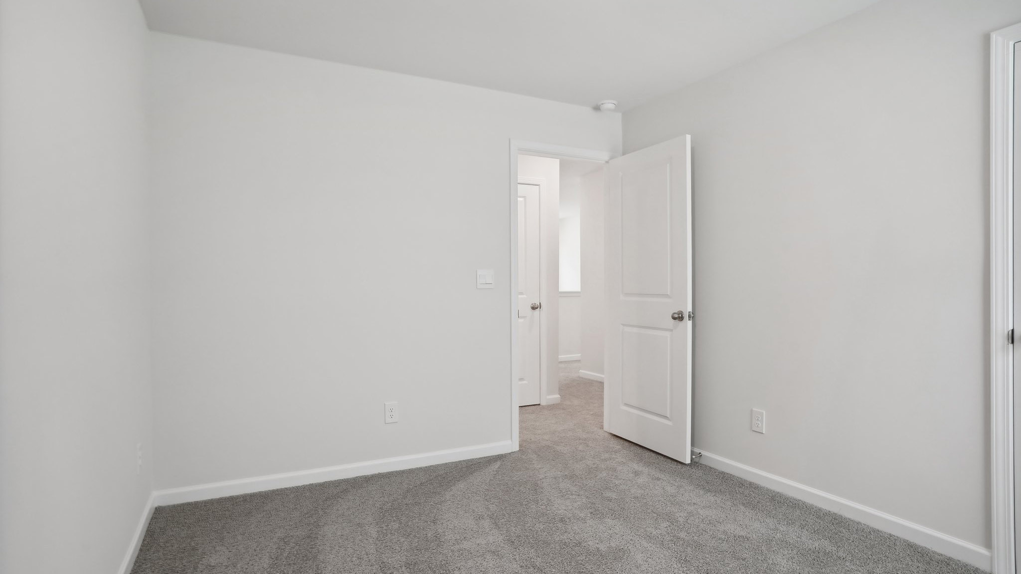 Carpeted bedroom with  window