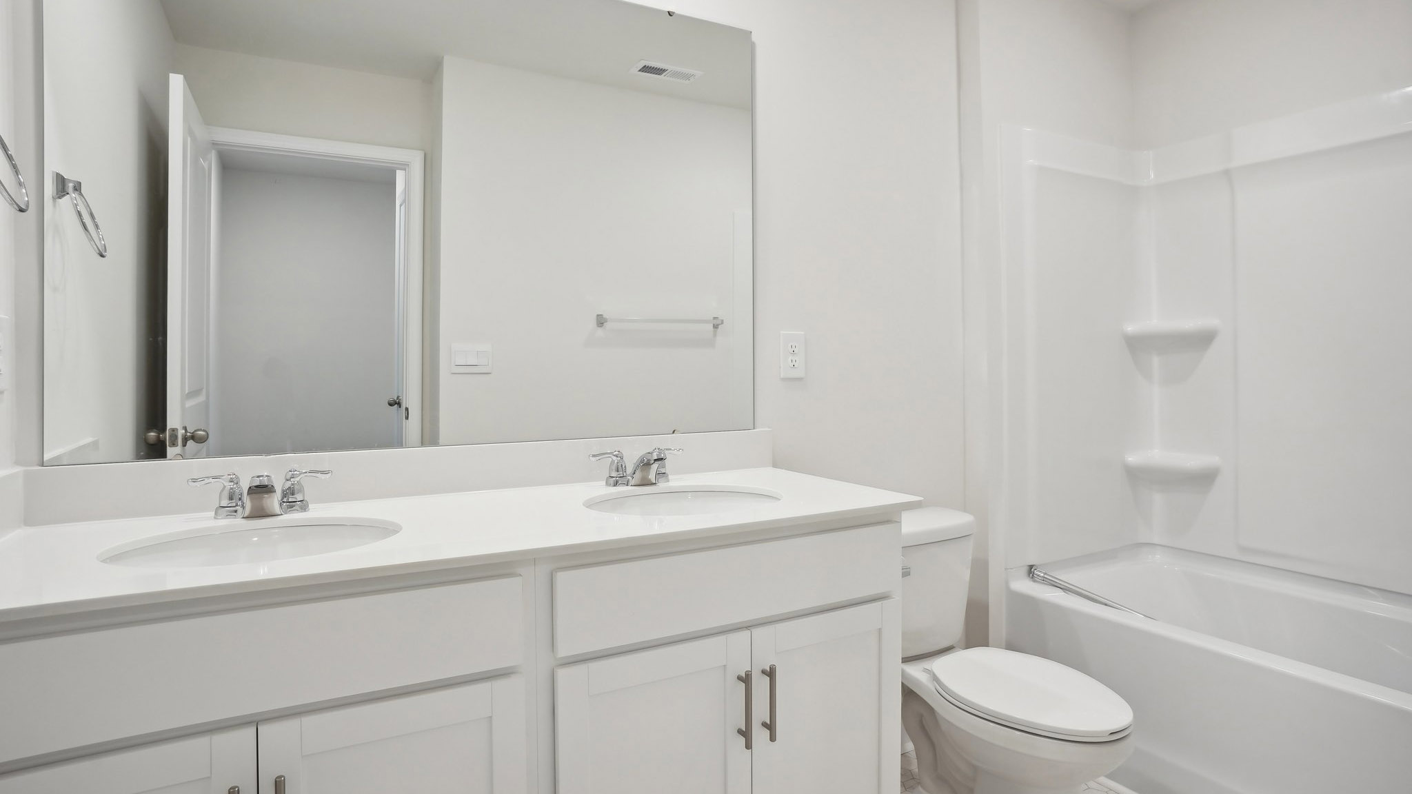 Bathroom with double sink vanity and bathtub shower combination