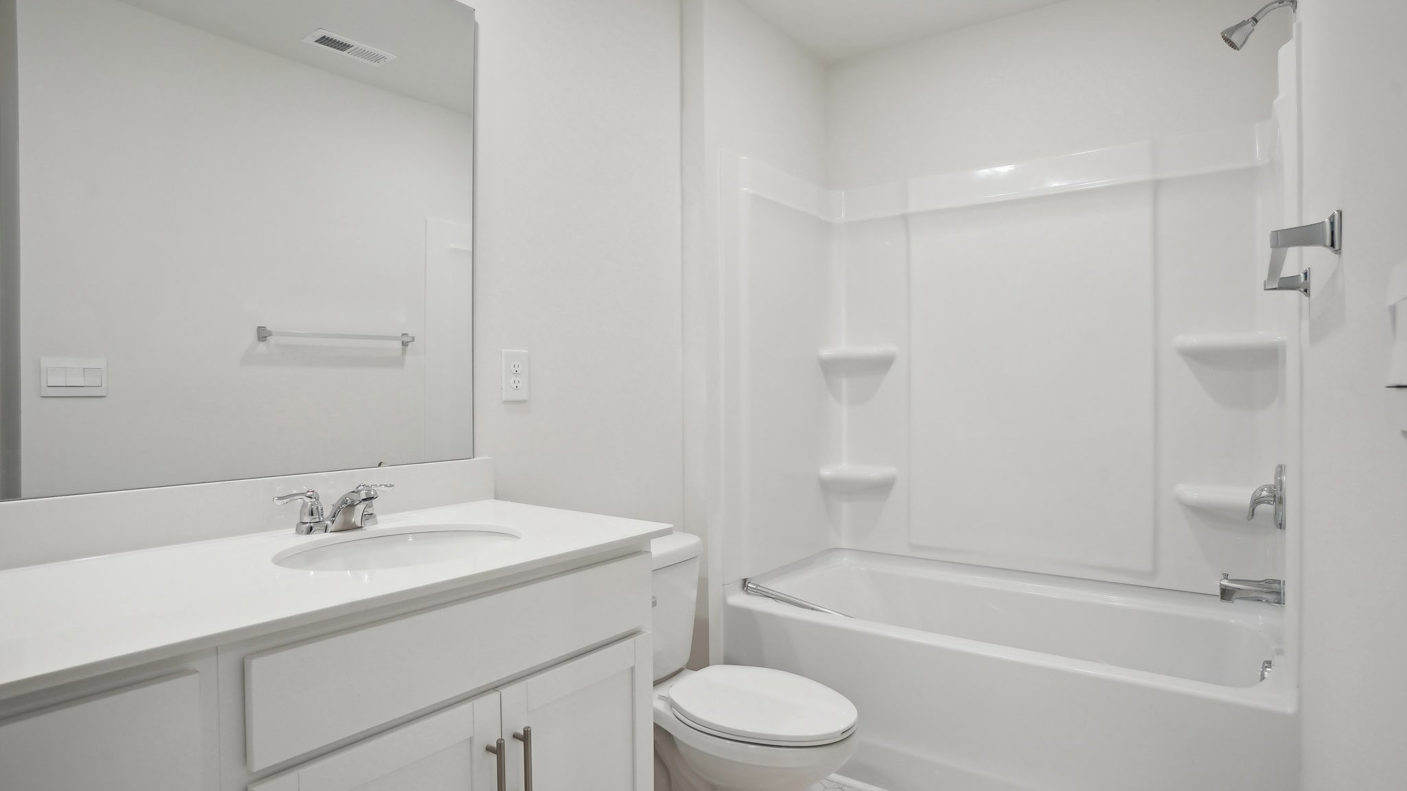 Bathroom with double sink vanity and bathtub shower combination