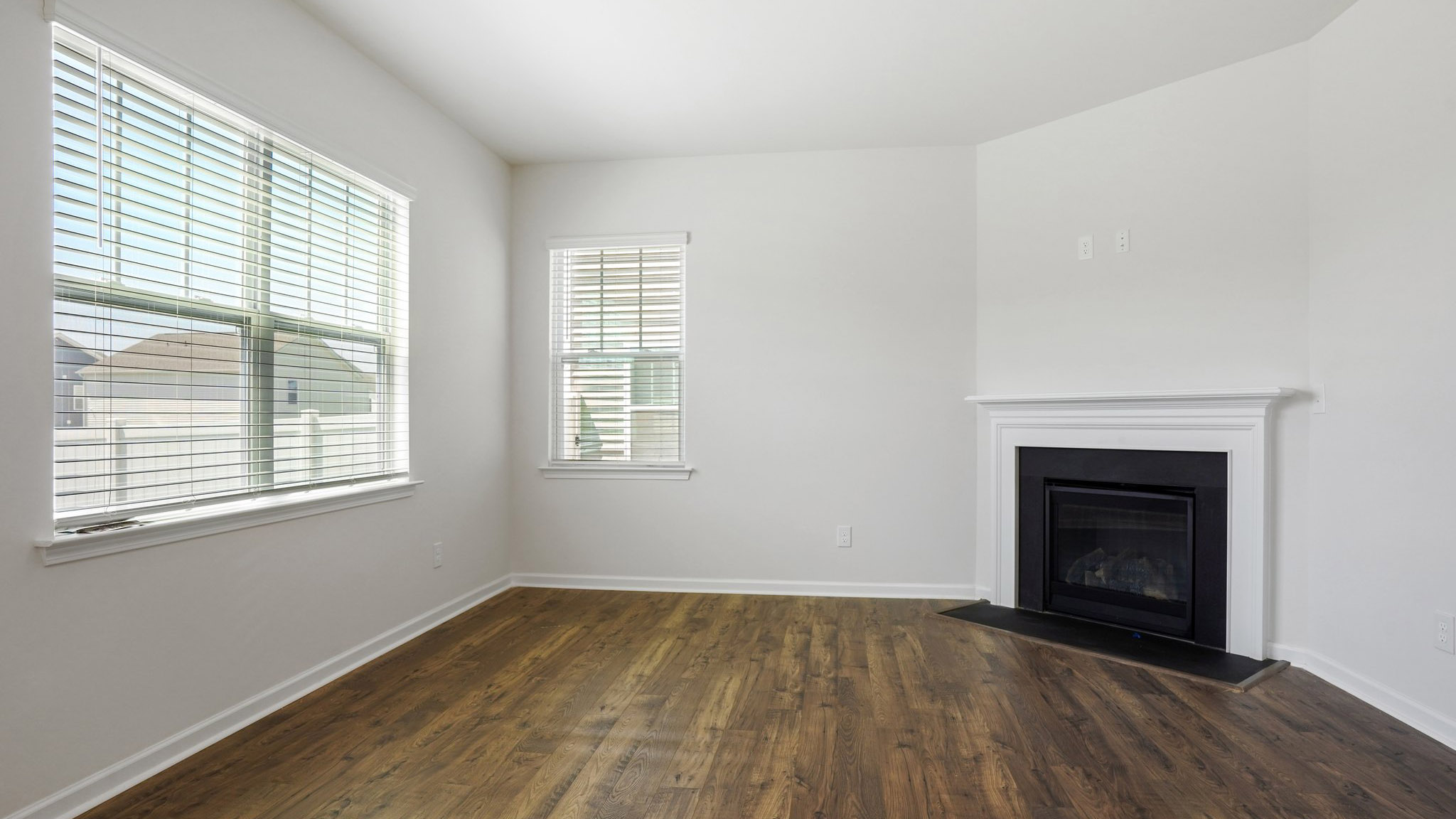 Living room with large window and electric fireplace