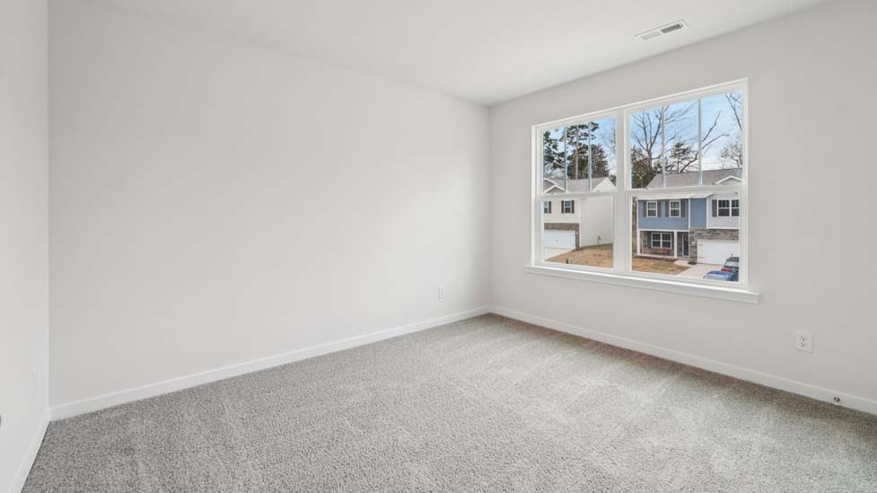 Carpeted bedroom with large window