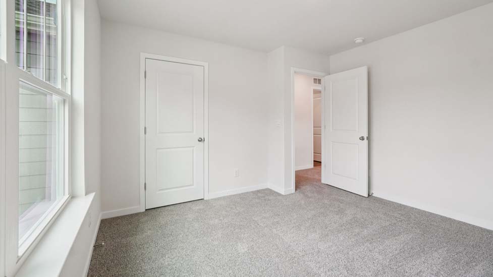Carpeted bedroom with large window