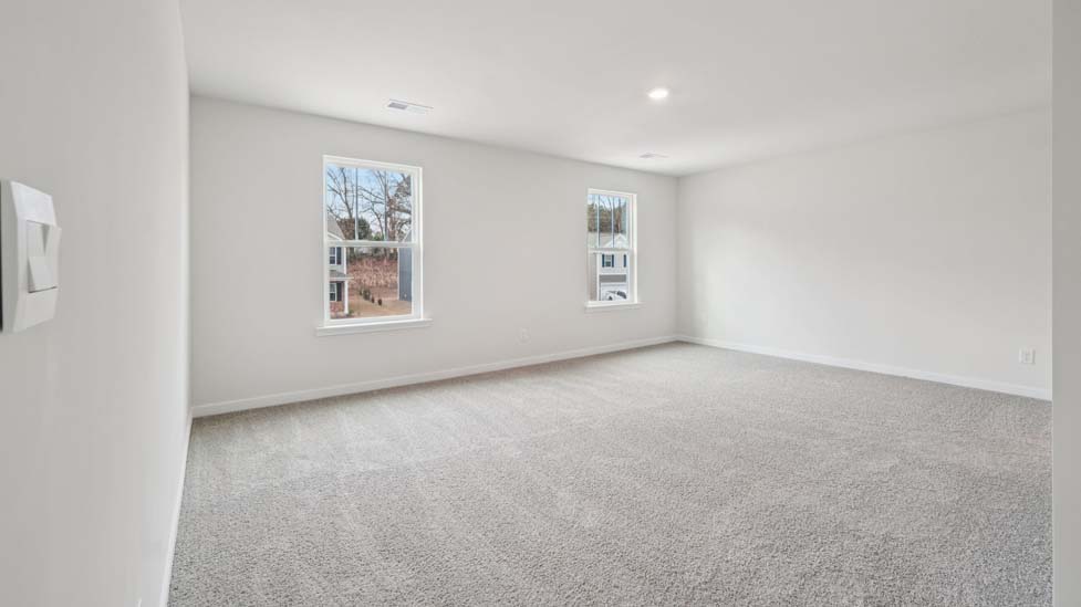 Carpeted bedroom with large window