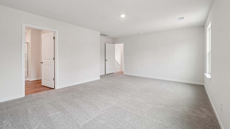 Carpeted bedroom with large window